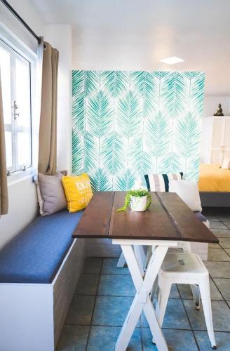 a table and a bench in a room at Romantic Dorado Beach Studio in Dorado