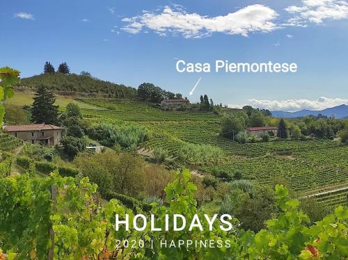 a view of a field with houses on a hill at Casa Piemontese in Mango