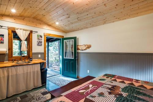 a bedroom with a bed and a sink at Unique Glamping Experience, Pet Friendly, Sleeps 2 in Maple Falls