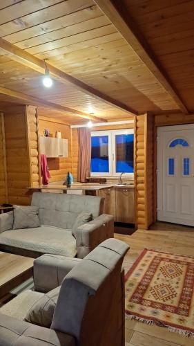 a living room with a couch and a kitchen at Villa Te Ibra - Rugovë in Peje