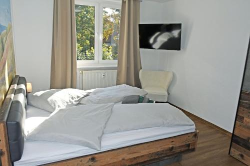 a room with three beds and a window at Baaber Hotel mit Frühstück in Baabe