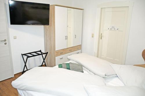 a room with two beds and a flat screen tv at Baaber Hotel mit Frühstück in Baabe