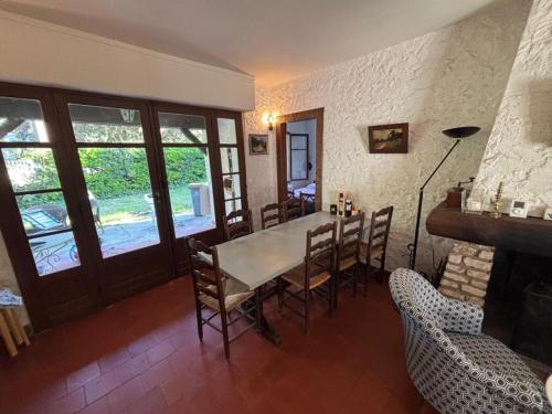 une salle à manger avec une table et des chaises et une cheminée dans l'établissement villa le mouleau, à La Teste-de-Buch
