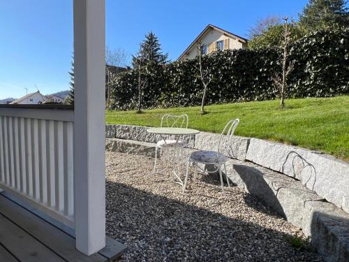 a patio with a table and chairs in a yard at Guesthouse Nunningen - Basel in Nunningen