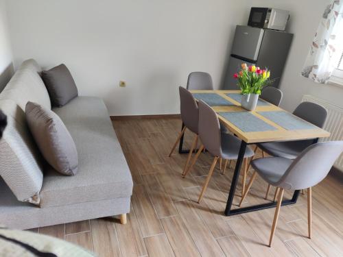 a living room with a table and a couch at Countryside house in Male Brusnice