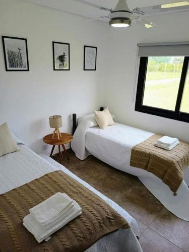 a bedroom with two beds and a window at Terrazas del Monte in San Miguel del Monte