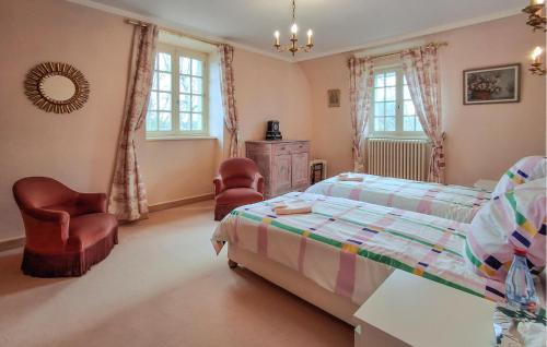 une chambre avec un lit et deux chaises dans l'établissement Gorgeous Home In Plélan-Le-Petit, à Plélan-le-Petit