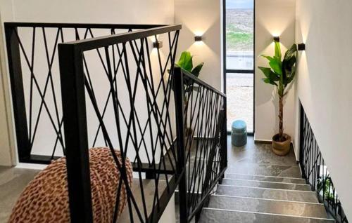 a room with a staircase with a bed and a window at Villa Solea in Dračan