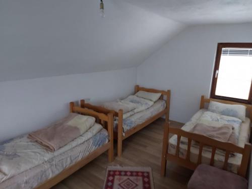 a room with three bunk beds and a mirror at Villa Te Ibra - Rugovë in Peje