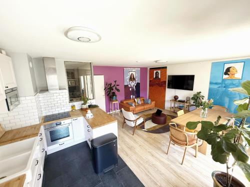 a kitchen and living room with a table and a couch at uta house la plaine in Saint-Denis
