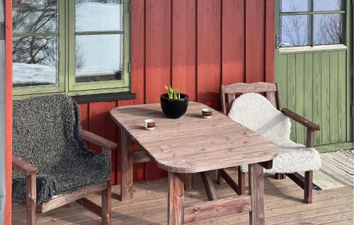 a wooden table and two chairs on a patio at Nice Apartment In Rauland With Wifi in Rauland
