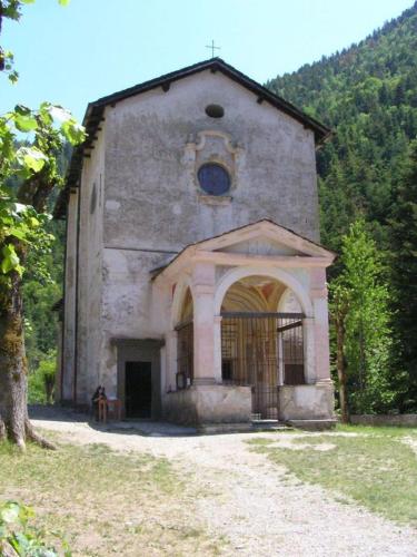 an old stone building with a window on the front at Hôtel Fleur des Alpes in La Brigue