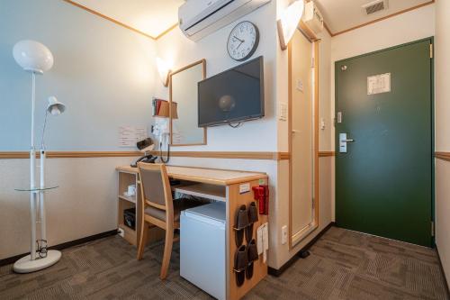 a room with a desk and a tv on the wall at Toyoko Inn Seoul Dongdaemun I in Seoul