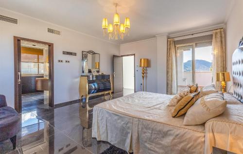 a bedroom with a large bed and a bathroom at Beautiful Home In Cox in Cox