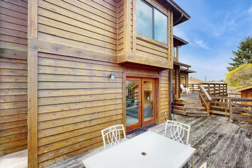 a house with a table and chairs on a patio at Tall Trees Lodge in Eureka