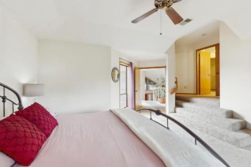 a bedroom with a bed with a red pillow at Tall Trees Lodge in Eureka