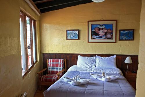 a bedroom with a bed with two towels on it at Samay Wasi Hostel in Cusco