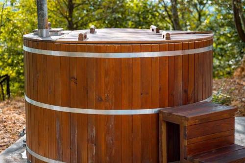 a wooden barrel with a wooden door in the woods at Sogno Proibito in Meldola