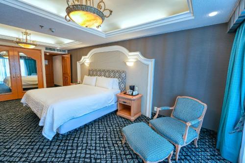 a hotel room with a bed and a chair at Holiday Inn Queretaro Centro Historico by IHG in Querétaro