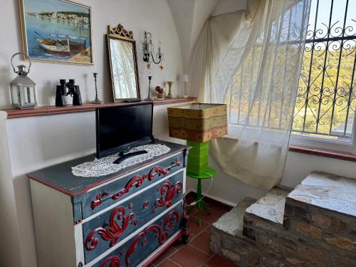 Zimmer mit einem TV auf der Kommode in der Unterkunft Casa Belvedere in Diano San Pietro