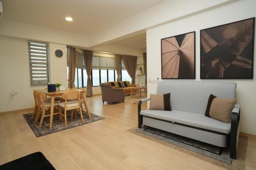 a living room with a couch and a table at Twynstar Mutiara Melaka Beach Resort in Tangga Batu