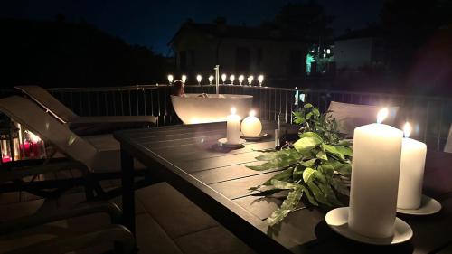 a table with candles on a patio at night at Villa Giulia Rooms & Bike in Toscolano Maderno