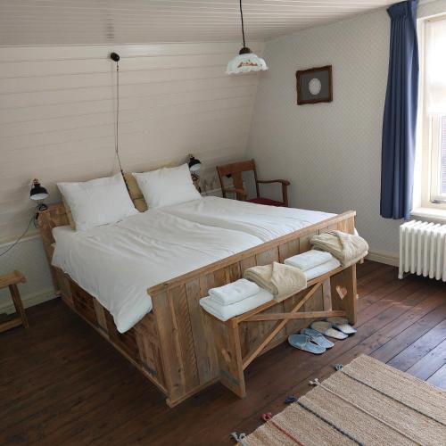 a bedroom with a large bed with white sheets at Bed&Breakfast ons Oda in Sint-Oedenrode