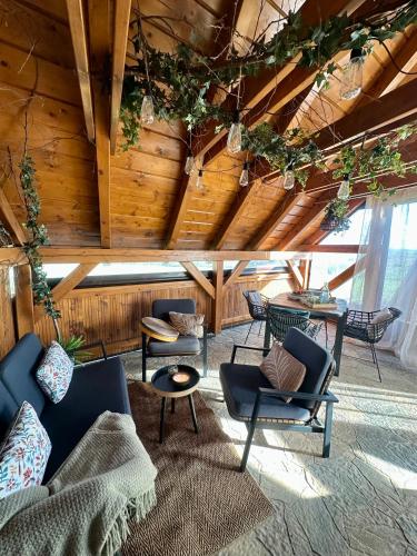 a living room with furniture and a wooden ceiling at Apartmán Ranč in Martin