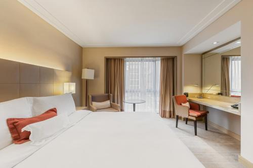 a hotel room with a large bed and a bathroom at InterContinental São Paulo by IHG in Sao Paulo