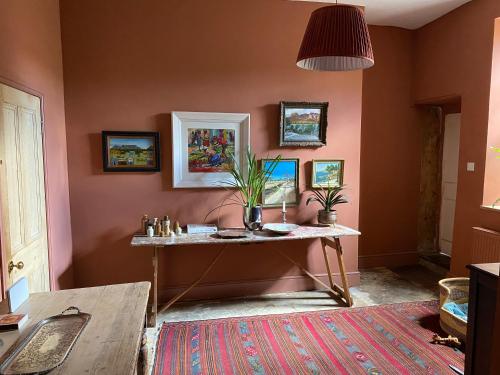 a room with a table with plants on it at Six on Castle in Tiverton
