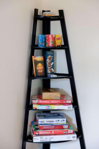 a black book shelf with books and snacks at Monte Cristo Home - Epic Backyard Pool Spa & Firepit in Surprise
