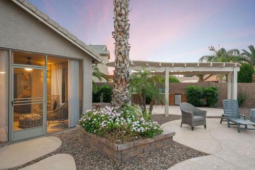 a house with a patio with a palm tree at Monte Cristo Home - Epic Backyard Pool Spa & Firepit in Surprise