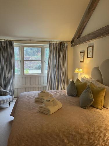 a bedroom with a large bed with towels on it at Tern Place in Kelling