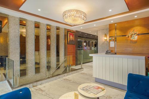 a lobby with a reception desk and a chandelier at Hotel Highway Greens Near VR Punjab Mall Airport Road Mohali Chandigarh in Mohali