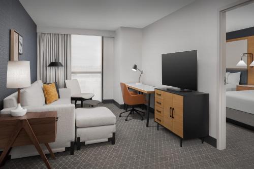 a hotel room with a bed and a television at Residence Inn by Marriott Seattle Northgate Station in Seattle