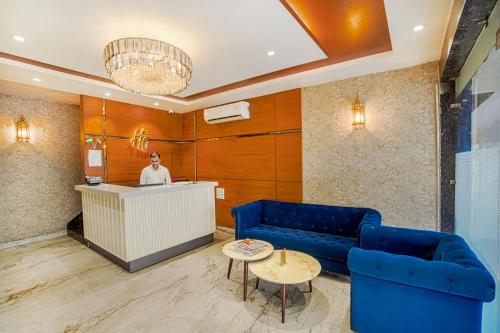 a woman standing at a counter in a hotel lobby at Hotel Highway Greens Near VR Punjab Mall Airport Road Mohali Chandigarh in Mohali