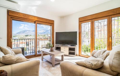 a living room with two couches and a flat screen tv at Nice Home In Jun With Wifi in Jun