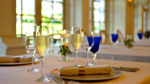 a table with wine glasses and a napkin on it at The Naha Terrace in Naha