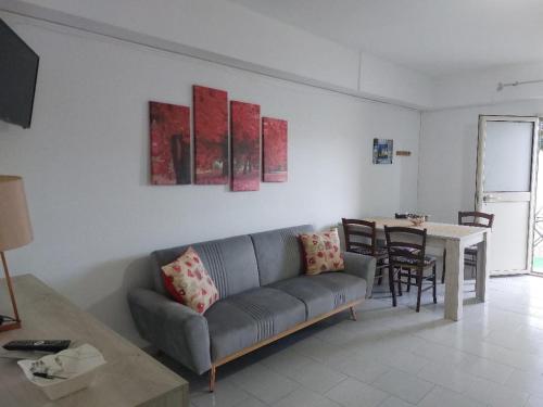 a living room with a couch and a table at Casa Samuel in Galtellì