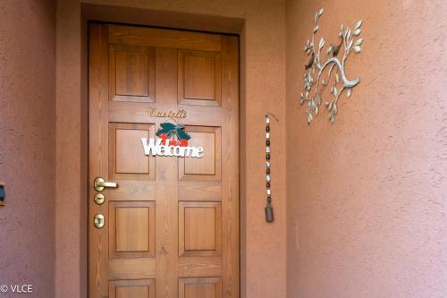 a door to a house with a welcome sign on it at La Casetta - panoramic view in Fiumelatte