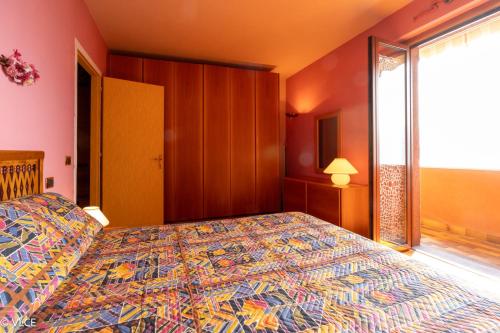 a bedroom with a bed and a large window at La Casetta - panoramic view in Fiumelatte