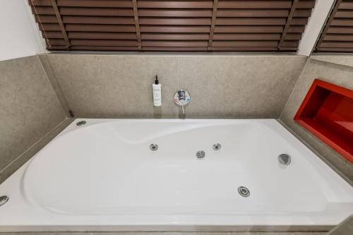 a white bath tub in a room with a bottle at InterContinental São Paulo by IHG in Sao Paulo