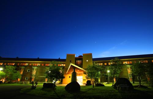 a large building at night with the lights on at Chuzenji Kanaya Hotel in Nikko
