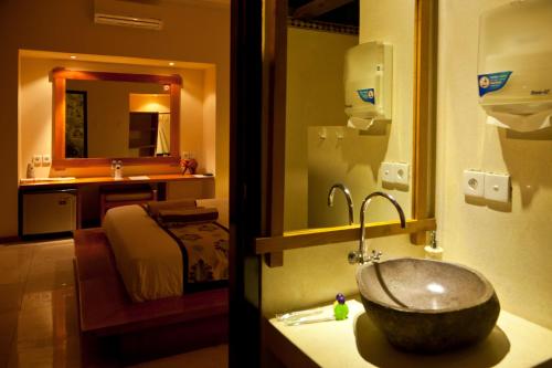 a bathroom with a sink and a bathroom with a bed at Taman Senang - Private Pool Villas - Gili Air in Gili Air