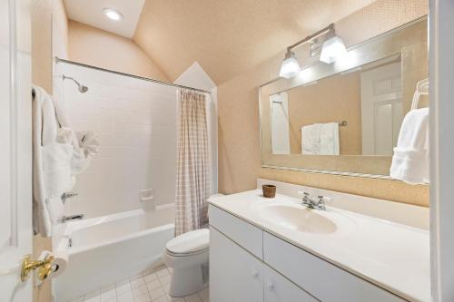 a bathroom with a sink and a toilet and a mirror at SM05: 5 Silver Moss in Kiawah Island