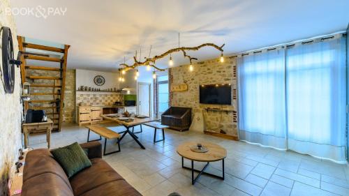 a living room with a couch and a table at La Grange des Richebourgs in Vauxaillon