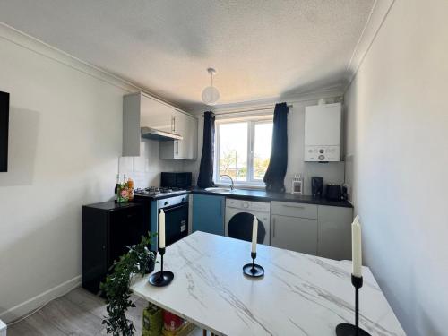 a kitchen with a table with two candles on it at Cosy Retreat in Greenwich