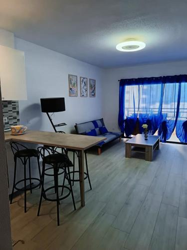 a living room with a table and a couch at Amazing doble beedroom apartment in Adeje