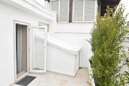 a white building with a door and a window at Carlotta Rooms in Conversano
