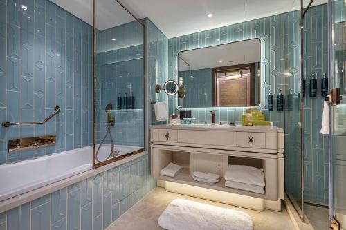 a bathroom with a sink and a mirror and a tub at Hilton Istanbul Bosphorus in Istanbul